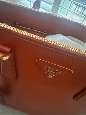 Authentic Prada Leather Satchel with Double Handles and double zippers.